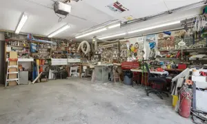Een georganiseerde garage met motor, fietswielen, helmen, ballen en posters. Inspirerende garage ideeen voor elke hobbyist.