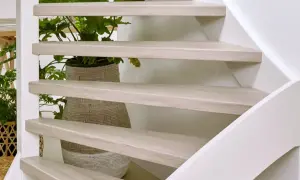 Lichte houten traptreden met planten erachter. Inspiratie voor open trap opknappen ideeën.