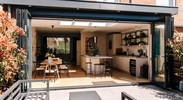 Moderne keuken en eethoek in een vergunningsvrij uitgebouwde achterzijde woning, met vouwdeuren naar terras.